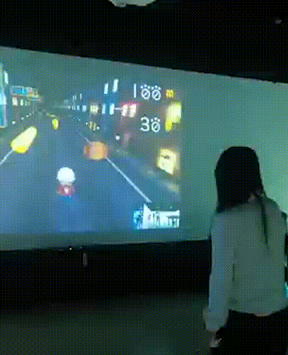 Interactive wall-mounted projector